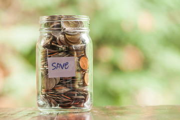 Jar of full coins in concept money saving