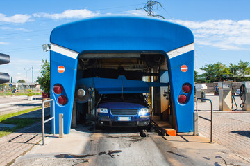 Automated portal carwash with a car running through.