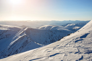 Fototapeta na wymiar majestic winter landscape of snowy mountains with clear blue sky