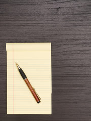 Wood Desk, Yellow Notepad, Pen