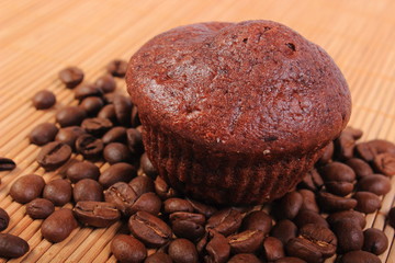 Fresh baked chocolate muffins and coffee grains