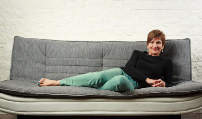 Senior Woman Sitting On Couch