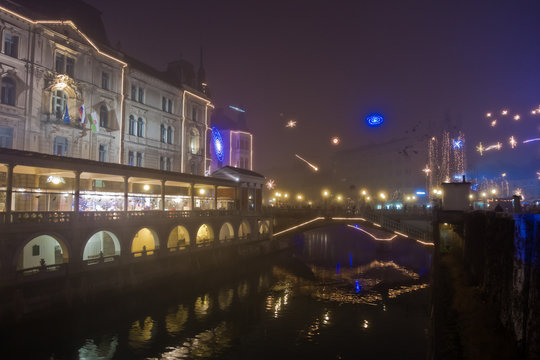 River Ljubljanica with three bridges at downtown of Ljubljana, Slovenia, decorated for Christmas holidays