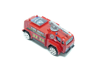 miniature toy fire truck on isolated white background