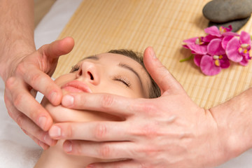Fototapeta na wymiar male hands of the masseur, cosmetologist, doing massage the girl
