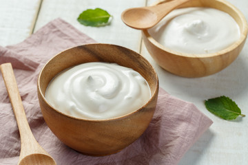 Homemade yogurt or sour cream in a wooden bowl