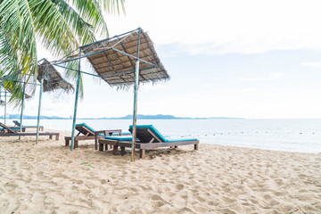 Obraz na płótnie Canvas Beach chair, Palm and tropical beach at Pattaya in Thailand