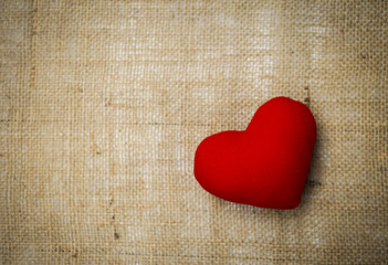 Red heart on hessian texture background, valentine background