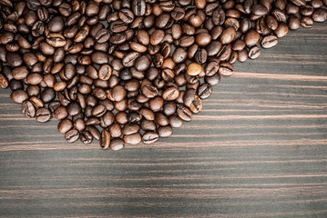 Coffee beans concept on wooden table background.