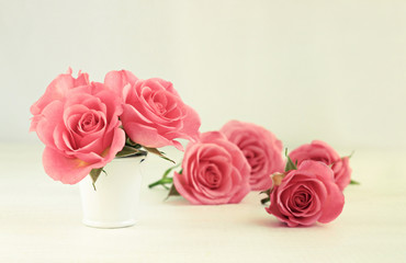 Pink rose flowers in little white tin bucket. Spring decor. Soft focus, Romantic warm creamy tones. 