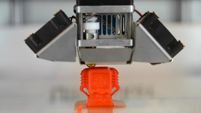 Building on new 3d printer printing isolated object orange on clean flat surface. Timelapse. Modern technology prototyping of plastic, other material. Printing with Plastic Wire Filament on 3D Printer