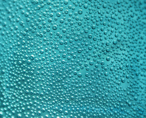 Oxygen bubbles in the bottle with water or drink. Selective focus on center with shallow depth of field.