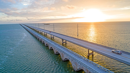 Fototapeta na wymiar Overseas Highway Seven Mile Bridge Traffic at Sunrise. View From Florida Keys Tropical Road to Paradise