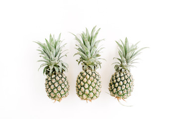 Pineapples on white background. Flat lay, top view. Creative food concept