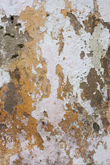 Peeling paint on cement wall.