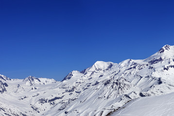 Panoramic view on off-piste slope and snow mountain at sun winte
