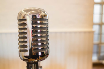 Vintage retro style microphone in white room