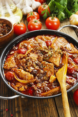 Pork stew with tomatoes and raisins