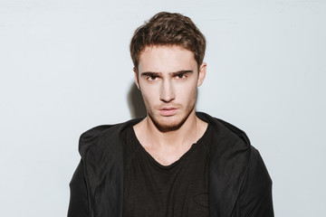 Young attractive man over white background.