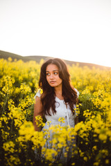 Fototapeta premium Young girl in yellow flower field