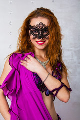 beautiful red-haired girl in a black lace mask