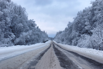 Obraz premium landscape Road in the winter forest with snow covered