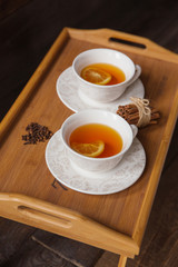 Herb tea with spice and lemon for two person. Selective focus