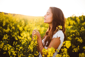 Young girl in yellow flower field