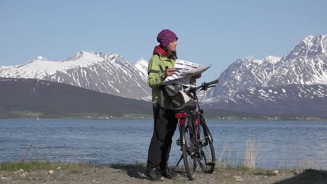 Woman at bicycle looking in map