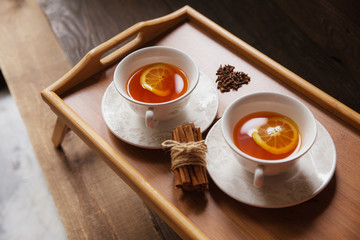 Herb tea with spice and lemon for two person. Selective focus