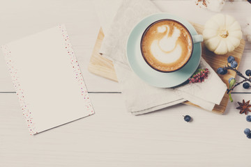 Pumpkin spice latte. Coffee top view on white wood background