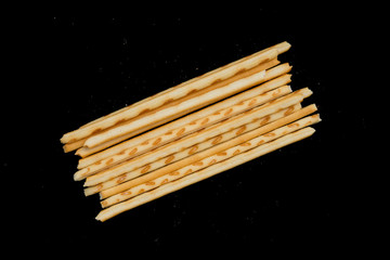 top view pretzel sticks on a black background