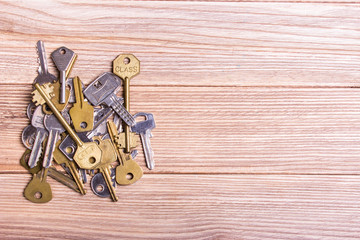 Older different keys on a old wooden table
