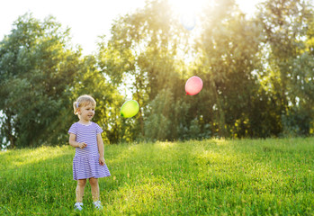happy girl with balloons outdoor