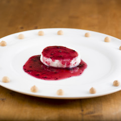 panna cotta with the seal of red berries