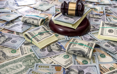 Wooden law gavel on us dollar money background