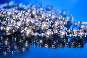 White pearls collier isolated on black blue background.
