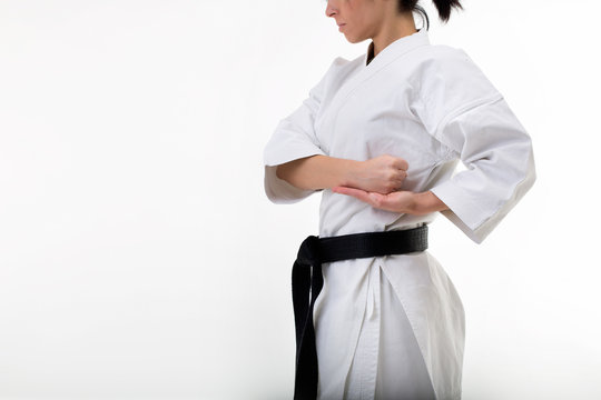 Closeup of female karate fighter body: studio picture on withe background