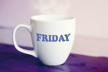 Obraz na płótnie Canvas white cup with the word Friday on it