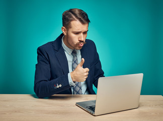 Sad Young Man Working On Laptop At Desk
