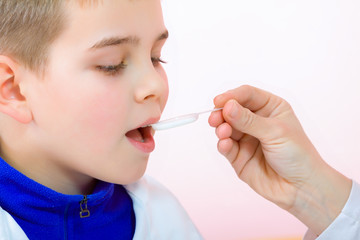 Little boy drinking syrup medicine liquid