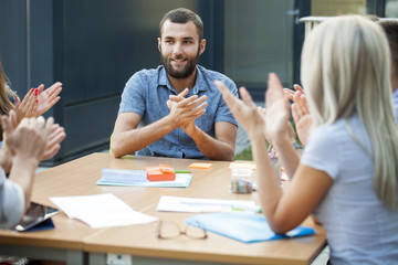 Business people clapping hands in workshop