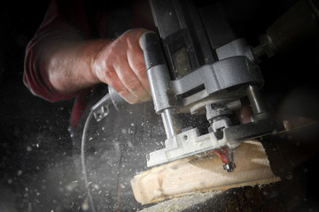 drill machine drilling a wood board