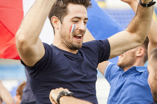 Portrait of male soccer fan celebrating in stadium