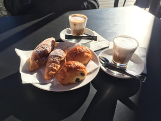 Italian breakfast with coffee cups and fresh croissants