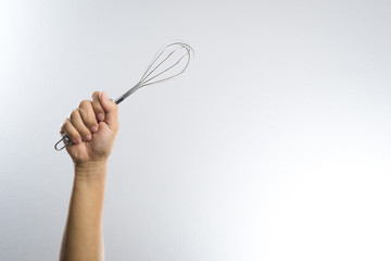 Hand holding stainless balloon whisk