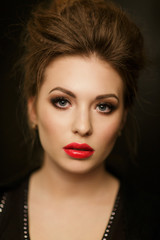 Fototapeta premium Beautiful brunette with red lips