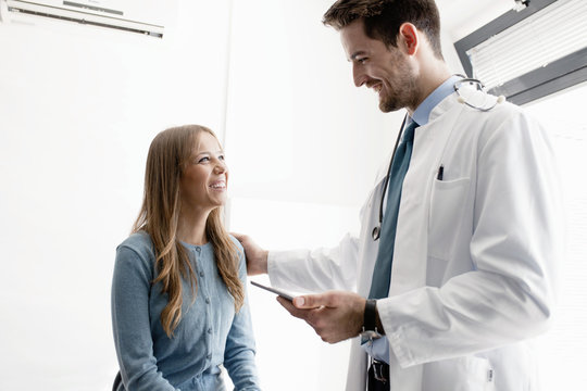 Doctor talking to female patient in hospital