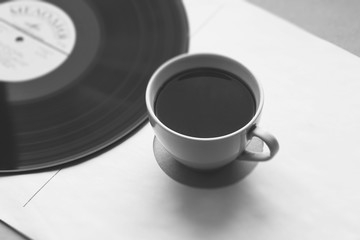 coffee cup on paper cover of vinyl record