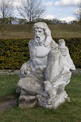 Fototapeta na wymiar Neptune statue in the garden of the castle in Zolochiv Ukraine. Vertical position